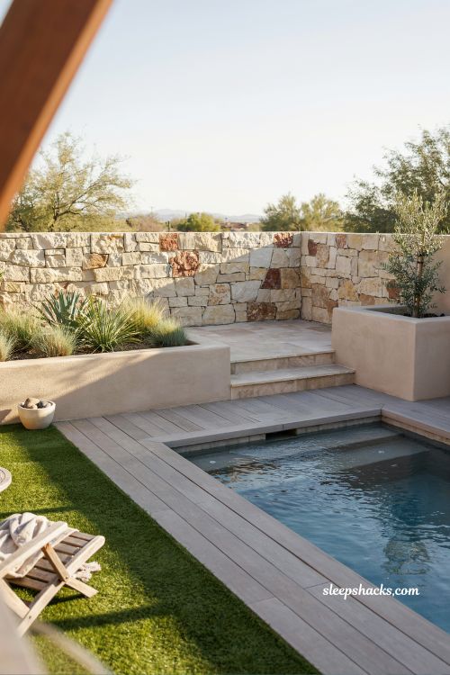 Small backyard pool design with artificial turf and modern decking creating a clean, low-maintenance outdoor space in a compact modern home setting