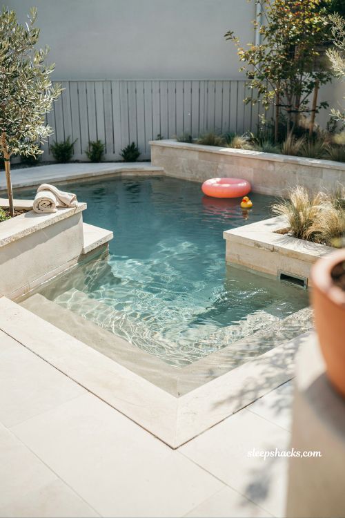 Small backyard pool with tanning ledge modern family friendly inground design compact 10x20 layout with baja shelf and clean stone decking