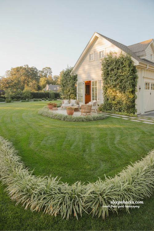 Small corner lot front yard landscaping with wraparound lawn ornamental grasses and patio seating