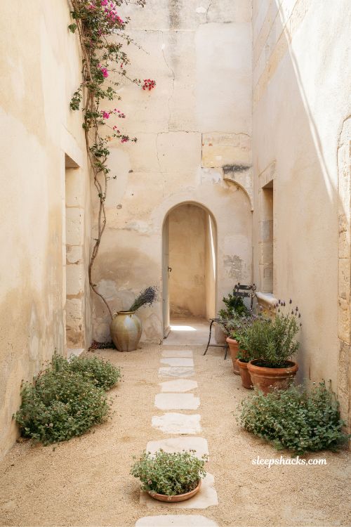 Small mediterranean garden ideas with decomposed granite paths and stepping stone accents in a rustic courtyard layout 