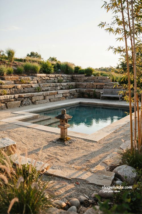 Small sloped backyard ideas with Japanese stone lantern near zen pool steps design