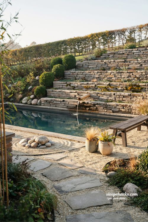 Small sloped backyard ideas with bamboo water feature and peaceful zen pool design