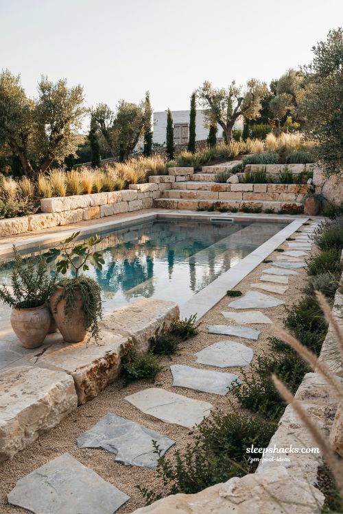 Small sloped backyard ideas with natural stone pool coping and seamless garden design
