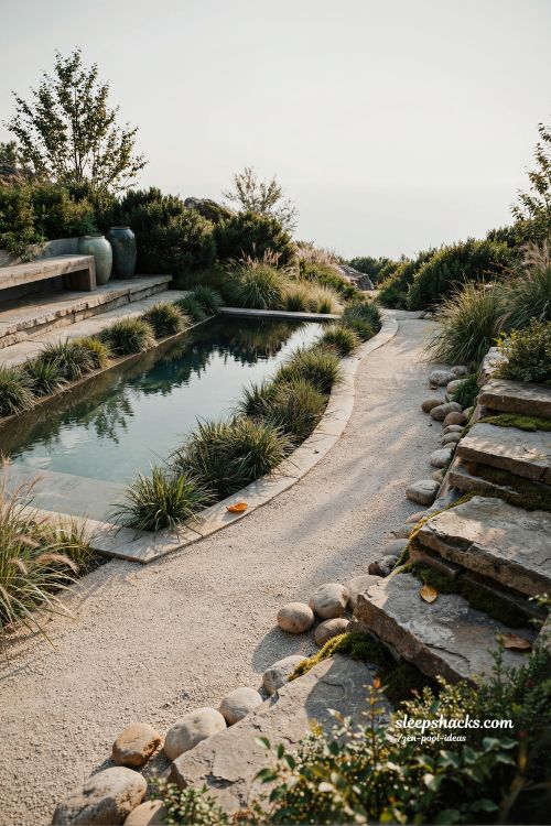 Small sloped backyard ideas with zen pool and low Japanese ornamental grasses