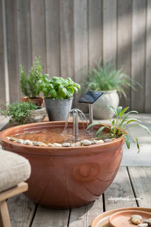 Solar powered container pond idea with fountain in a patio planter garden