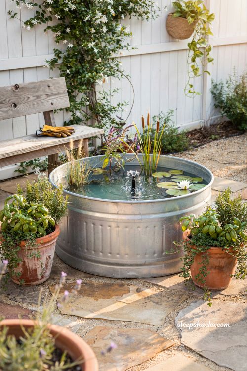 Stock tank pond patio idea with solar fountain and modern farmhouse charm