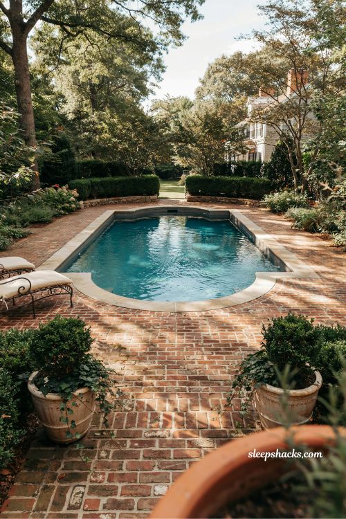 Stone coping pool with brick deck for a timeless classic backyard design