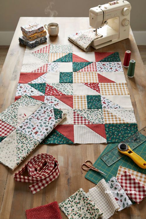Strip pieced christmas jelly roll throw quilt on cozy couch with festive red green striped fabric design