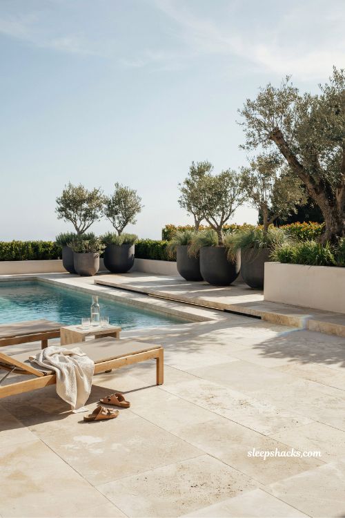 Travertine tile pool decking design that stays cool in summer sunlight