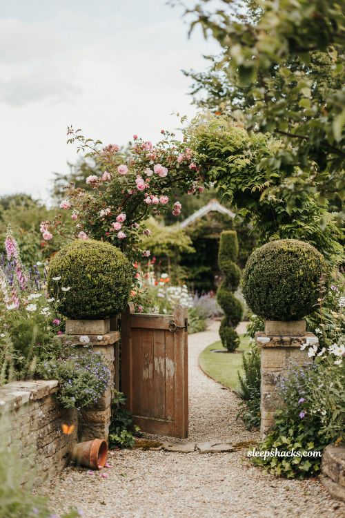 Whimsical backyard ideas with topiary garden gate and storybook shaped greenery entrance design