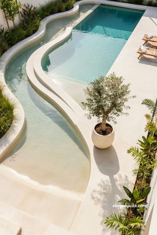 Zero entry lazy river flowing into main pool seamless backyard resort design ideas