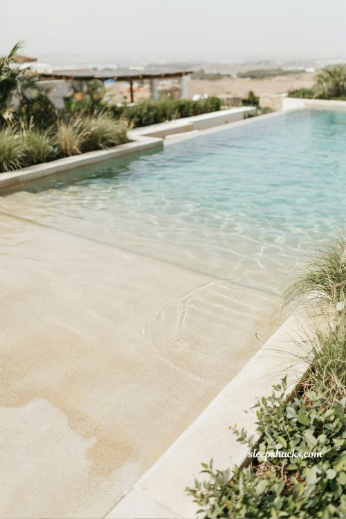 beach entry pool with built in tanning ledge shallow water lounging design