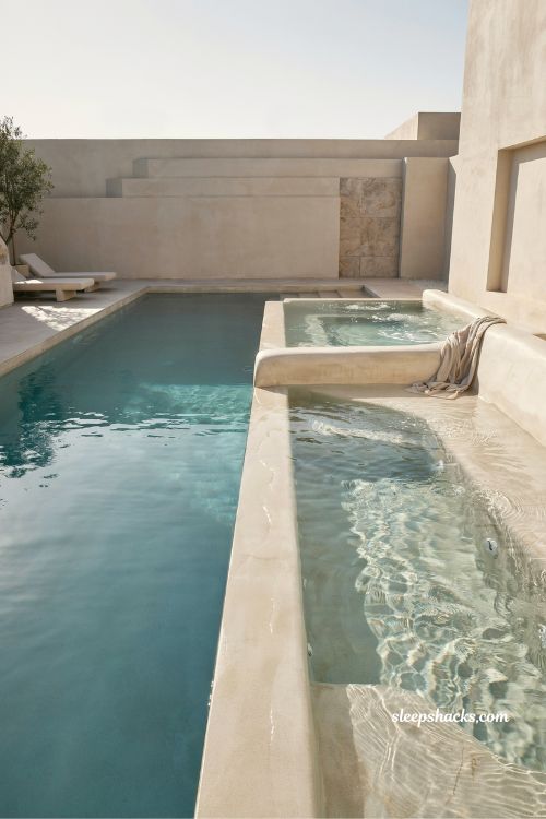 built in jacuzzi seating pool design with luxury marble look spa edge and modern villa relaxation aesthetic