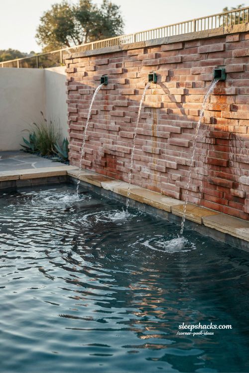 corner water feature wall with copper scuppers backyard pool design rustic modern masonry water feature idea
