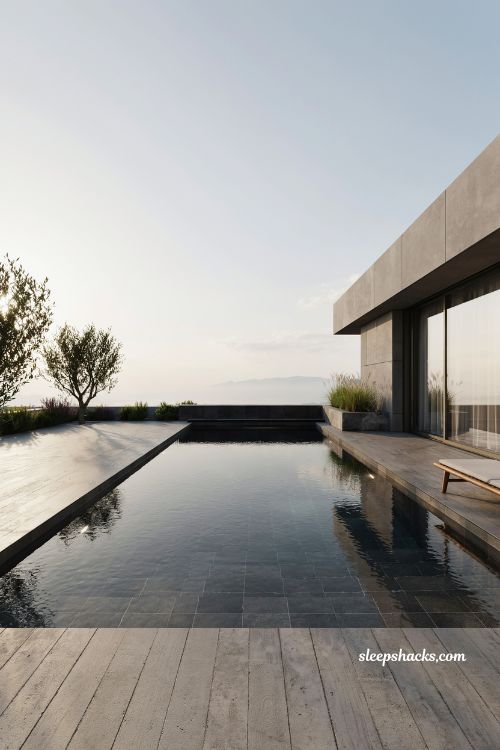 dark tiled pool design with deep reflective water and modern luxury villa minimalist aesthetic