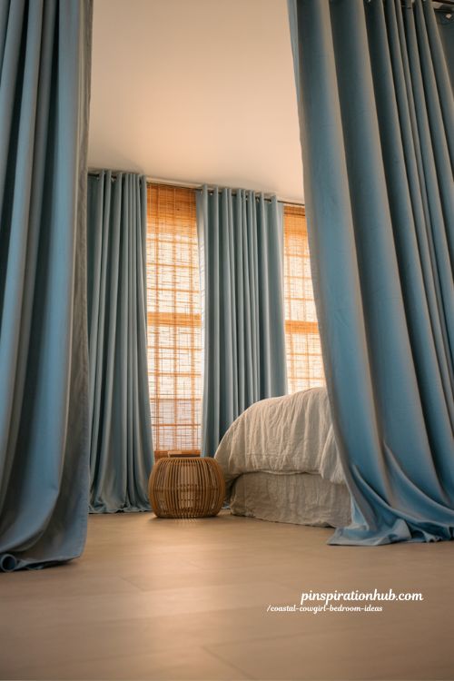 dusty blue velvet curtains coastal cowgirl bedroom with bamboo shades layered window treatment and soft natural boho lighting