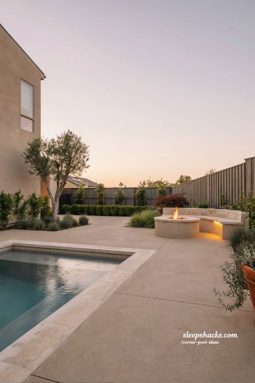 fire pit sitting area anchoring opposite corner from pool backyard design with dual focal points outdoor layout idea