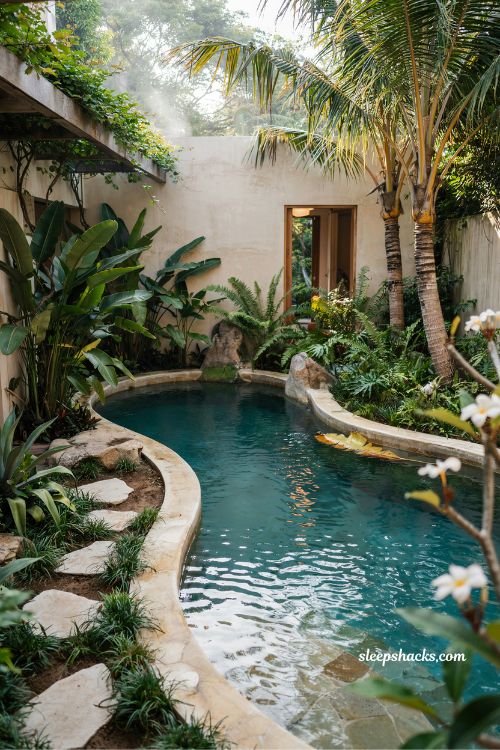 freeform lagoon pool design with natural curves and tropical villa garden integration aesthetic