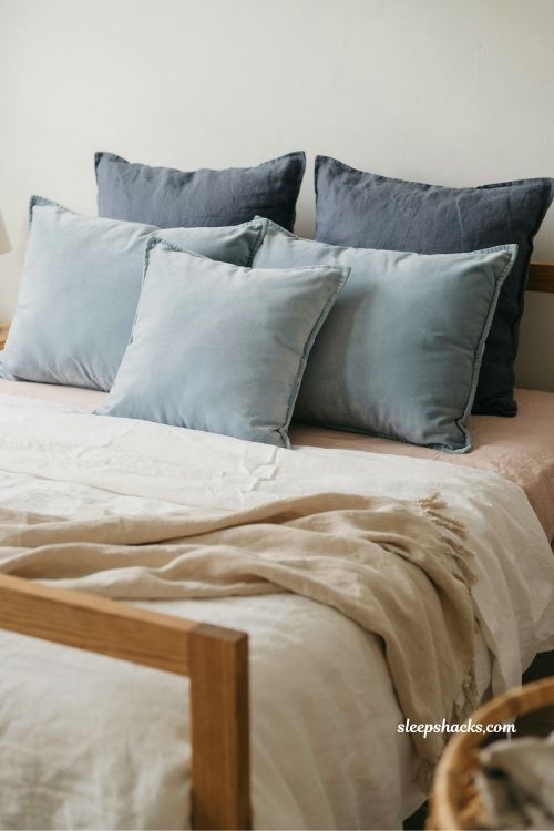layered blue pillow arrangement pink and blue coastal bedroom idea with textured coastal bedding styling