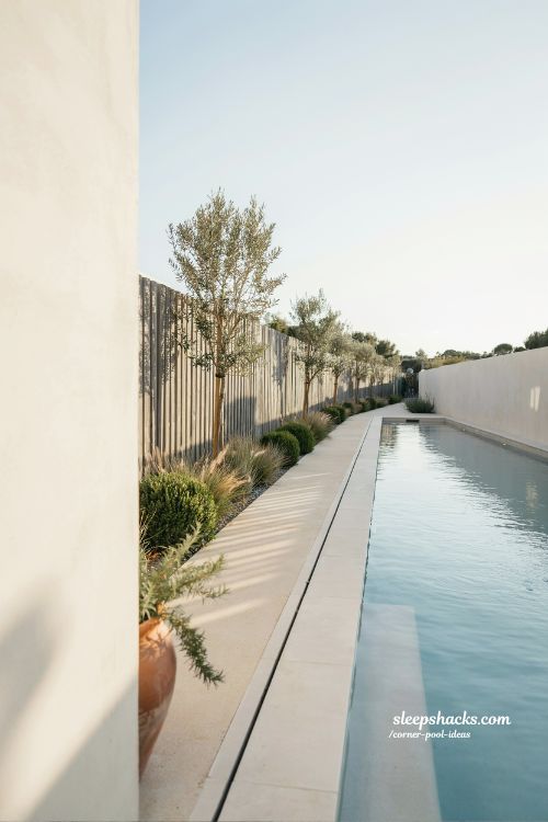 long narrow pool running full fence line corner lot modern minimalist lap pool design ideas backyard