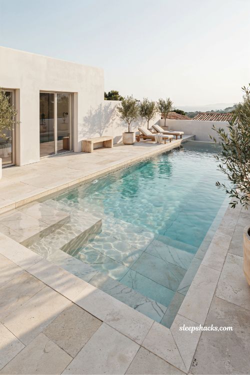 minimalist white pool design with marble look finish and timeless modern villa luxury aesthetic