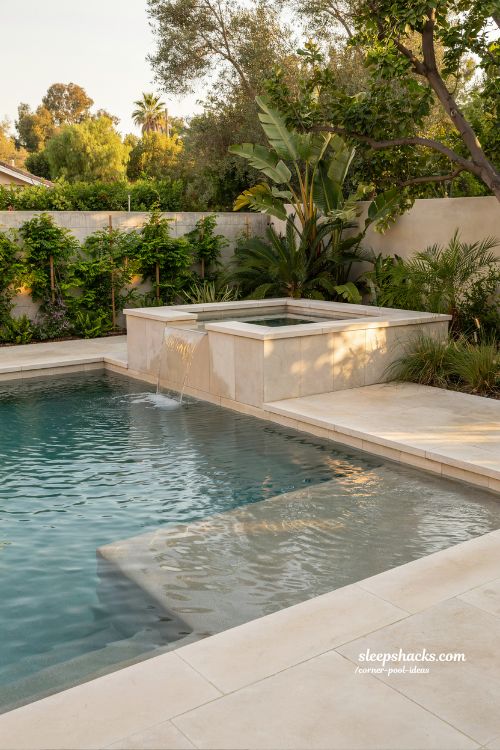 raised spa in corner with spillover into pool luxury backyard water feature design resort style pool idea