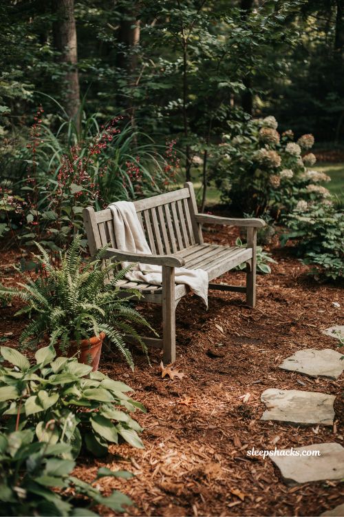 shaded backyard reading corner with mulch ground cover and cozy garden seating nook