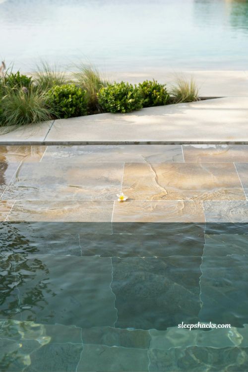 shallow beach entry pool with gradual wading zone and natural family friendly design