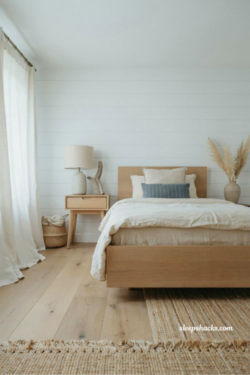shiplap accent wall coastal bedroom idea for a bright cottage style interior
