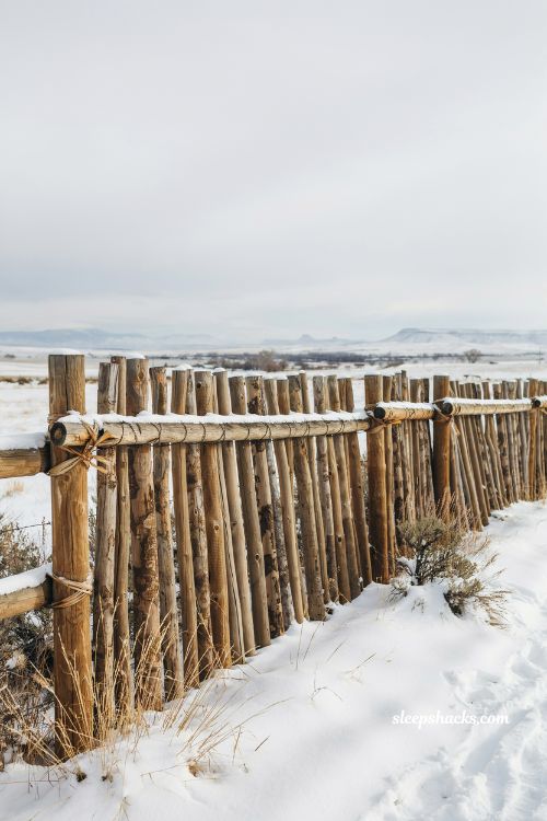 snow covered coyote fence rustic southwestern wooden privacy wall ideas winter landscape inspiration