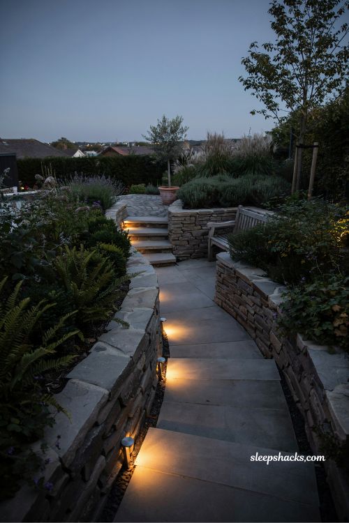 solar step lighting ideas for small sloped backyard garden stairs at night with glowing pathway design