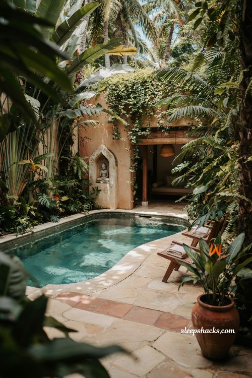 tropical villa pool design surrounded by lush greenery and terracotta tile resort style oasis aesthetic