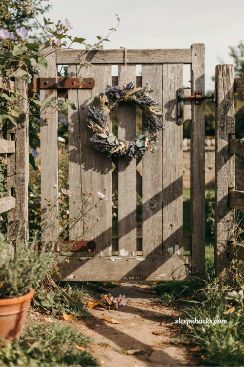 wooden garden gate with seasonal wreath rustic farmhouse entrance ideas with natural handmade decor and cozy cottage charm