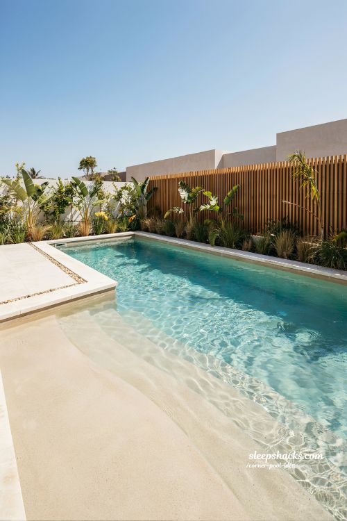 zero entry beach design starting from corner backyard pool gentle slope lagoon style swimming pool idea
