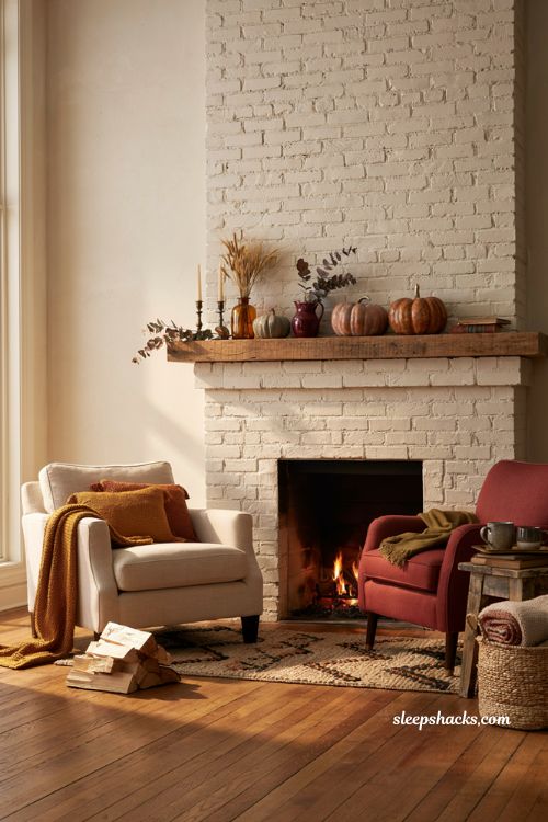 Autumn fireplace decor with cozy seating area and layered fall textiles