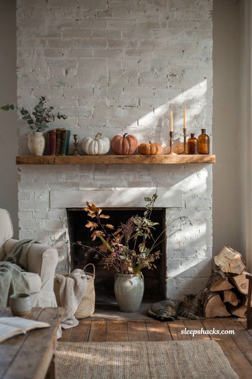 Autumn fireplace decor with foraged fall branches and natural mantel styling