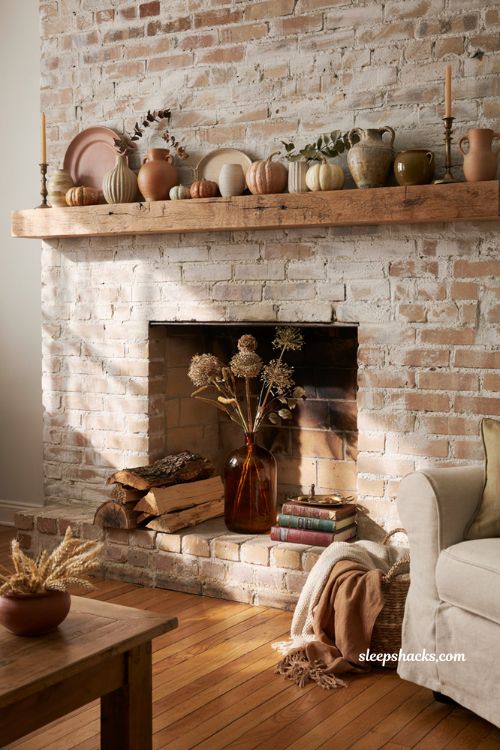 Autumn fireplace decor with vintage pottery and rustic hearth styling