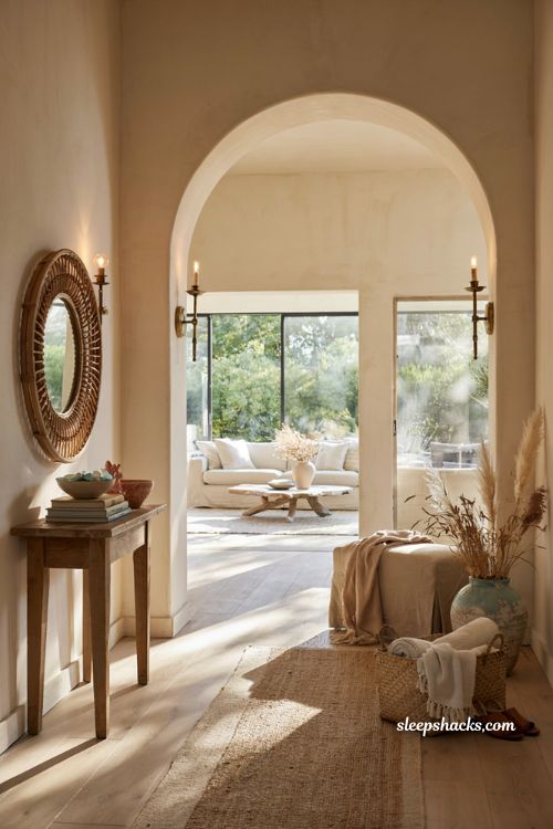 Beach house entryway ideas with arched doorway and light filled coastal interior