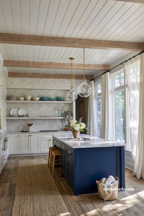 Beachy kitchen decor ideas with bold navy coastal island and white shaker cabinets
