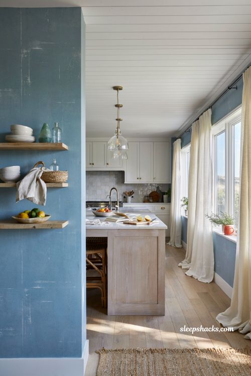 Beachy kitchen decor ideas with sea glass blue walls and warm coastal accents