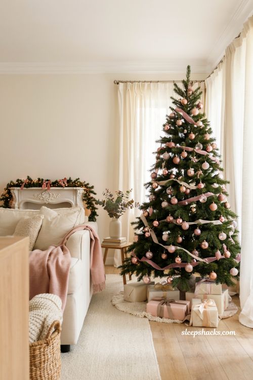 Blush pink and rose gold Christmas living room decor idea with pastel ornaments and cream furniture