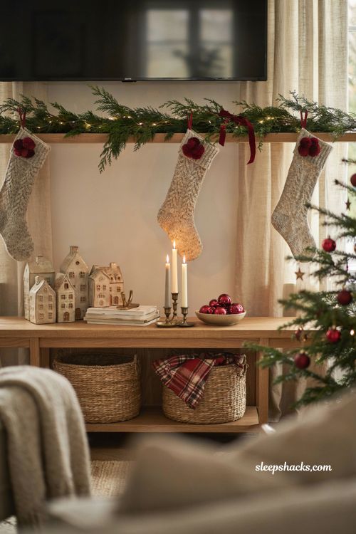 Christmas decor ideas for a living room tv stand with bold red holiday accents and neutral styling