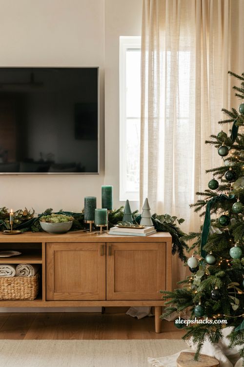 Christmas decor ideas for a living room tv stand with elegant monochromatic evergreen styling