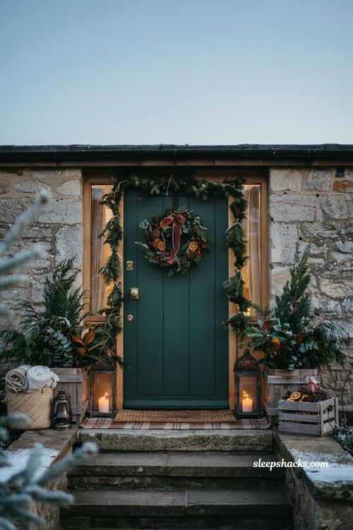 Christmas front door ideas with classic wreath natural greenery lanterns and cozy farmhouse holiday entrance