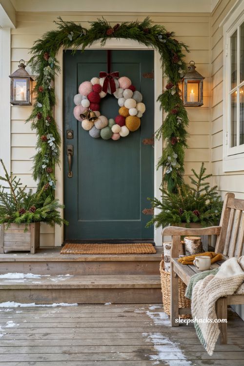 Christmas front door ideas with colorful pom pom wreath and cozy farmhouse porch