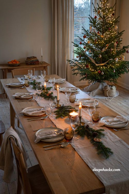Christmas table settings ideas with dining table near glowing christmas tree