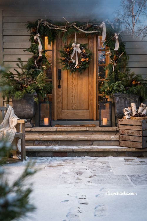 Christmas yard decorations ideas with handmade twig garland layered over evergreen farmhouse porch decor