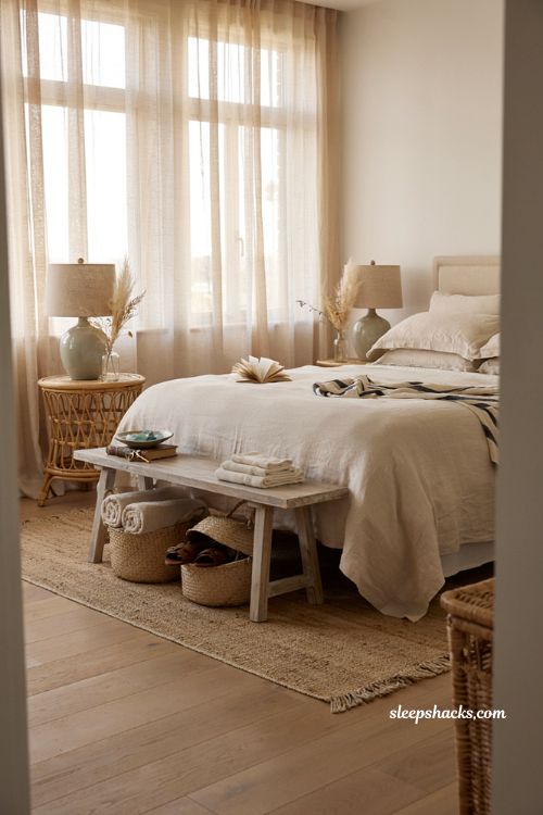 Coastal bedroom with soft linen bedding cotton textiles and airy seaside decor