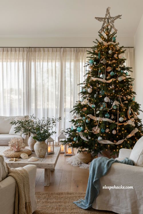 Coastal christmas living room with a driftwood tree topper and seaside holiday decor