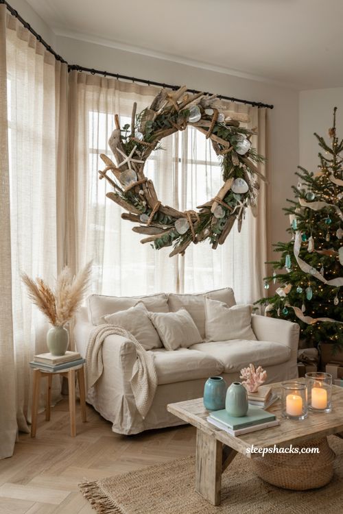 Coastal christmas living room with a driftwood wreath above the sofa and seaside holiday decor